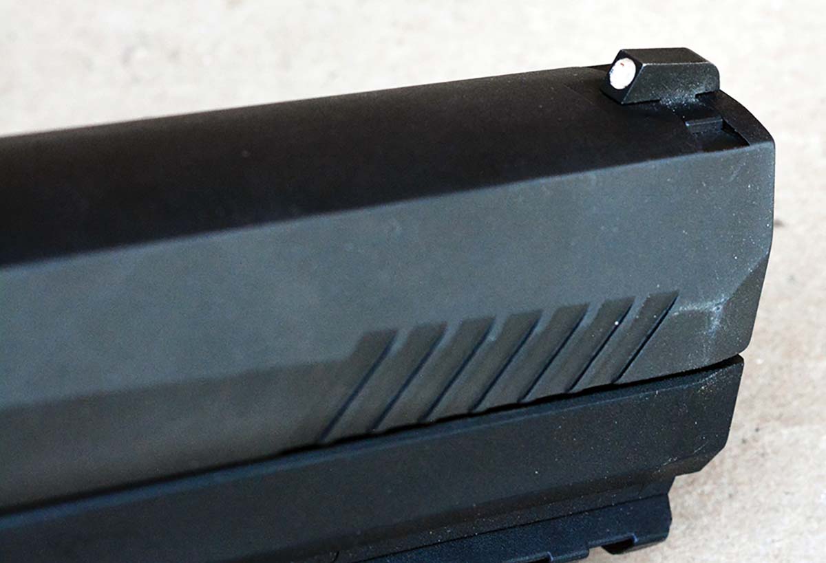 The front sight features a white dot and is dovetail mounted into the slide.